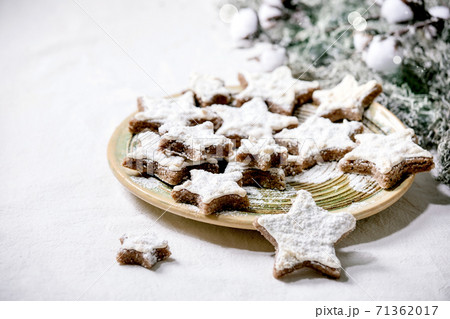 Star shape cocoa cookies with white glaze. Christmas decorations. Copy space 71362017