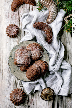 Christmas shortcrust cookies chocolate crescents with fir tree, molds, xmas decorations. Top view 71362030