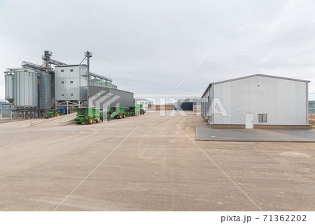 modern agricultural enterprise appearance. Industrial buildings made of galvanized metal, cloudy day modern agricultural enterprise appearance. Industrial buildings made of galvanized metal, cloudy day 71362202