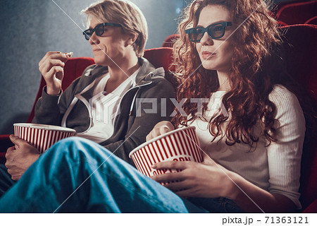 Beautiful woman with a man sitting in the cinema. Beautiful woman with a man sitting in the cinema. 71363121