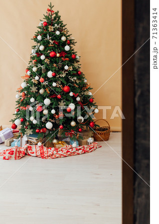 New year interior with Christmas tree with gifts decor garland December 71363414