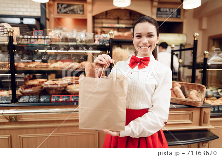 Young Smiling Woman Standing with Bread in Bakery. Young Smiling Woman Standing with Bread in Bakery. 71363620