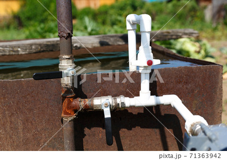 Plumbing from plastic pipes with a connection to a metal column. 71363942