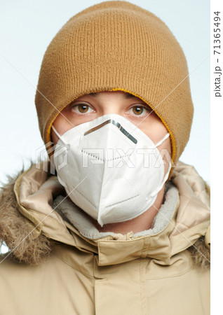 Man in medical mask in winter coat 71365494
