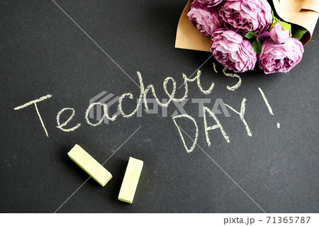Flat lay composition with flowers peonies bouquet and inscription TEACHER'S DAY on black chalkboard 71365787
