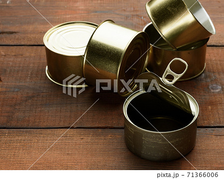 empty metal can for canned fish on a brown wooden background empty metal can for canned fish on a brown wooden background 71366006