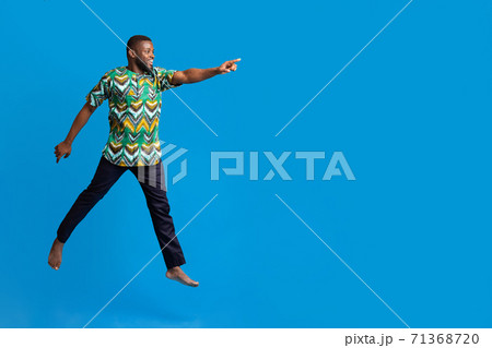 Excited black man running towards copy space for advertisement 71368720