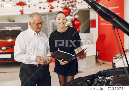 Stylish and elegant old man in a car salon 71370724
