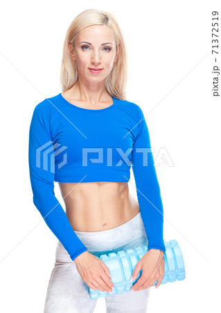 Beautiful fitness girl is standing with a mat ready to workout isolated on white background 71372519