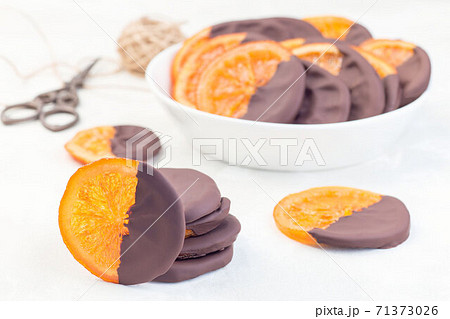 Homemade candied sliced oranges covered with chocolate, horizontal Homemade candied sliced oranges covered with chocolate, horizontal 71373026