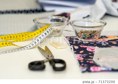 tailors tape measure on a sewing table in a tailor shop tailors tape measure on a sewing table in a tailor shop 71373200