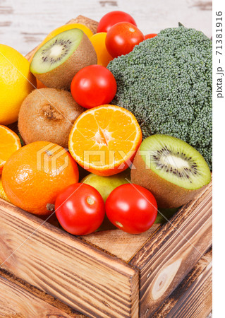 Heap of ripe fruits with vegetables in rustic box 71381916