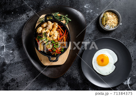 Stir fry noodles with vegetables, chicken. Wok noodles. Black background. Top view Stir fry noodles with vegetables, chicken. Wok noodles. Black background. Top view 71384375