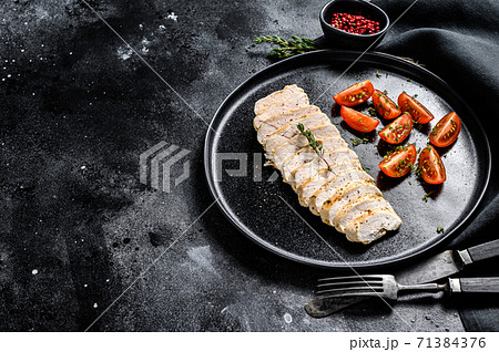 grilled chicken breast with fresh cherry tomatoes. Healthy diet food. black background. Top view. Copy space 71384376
