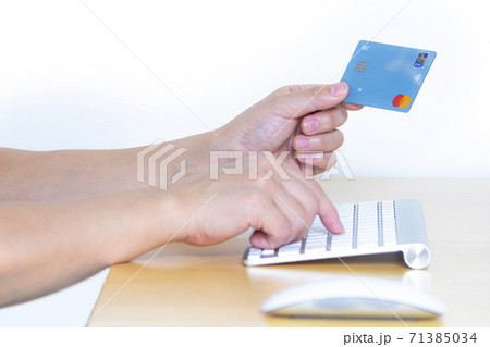 Calgary Alberta, Canada. Nov 10, 2020. A Person online shopping with a Master Card, credit card and a computer Calgary Alberta, Canada. Nov 10, 2020. A Person online shopping with a Master Card, credit card and a computer 71385034