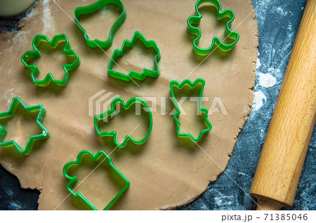 Christmas homemade cookies preparation. Top view of ginger dough biscuits laying on table. Christmas and New Year holidays Christmas homemade cookies preparation. Top view of ginger dough biscuits laying on table. Christmas and New Year holidays 71385046