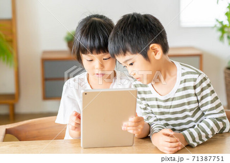 兄弟 タブレット 仲良し 女の子 男の子の写真素材