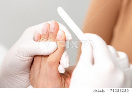 Hands polishing fingernails. Hands polishing fingernails. 71388280