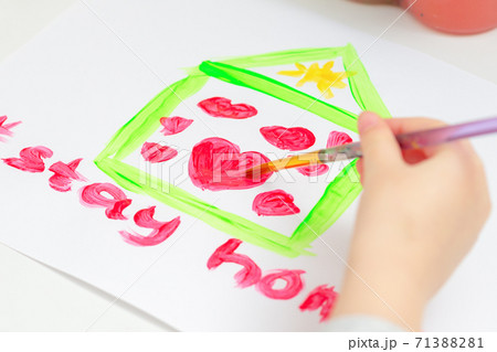 Child is drawing hearts into house. Child is drawing hearts into house. 71388281