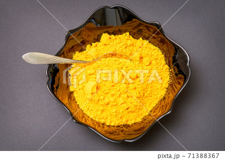 Turmeric powder in ceramic black bowl Turmeric powder in ceramic black bowl 71388367