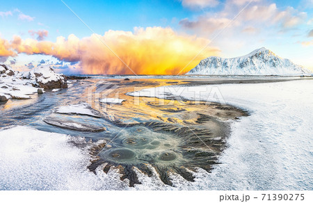 Outstanding  winter scenery on Skagsanden beach with illuminated clouds during sunrise. 71390275