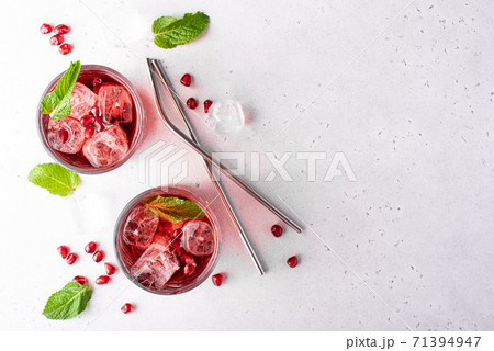 pomegranate juice with pomegranate seeds, mint and ice pomegranate juice with pomegranate seeds, mint and ice 71394947