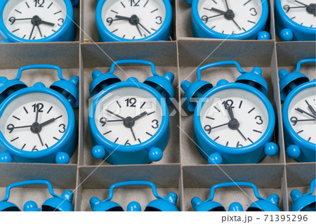 Colored clock alarm clocks in a cardboard box 71395296
