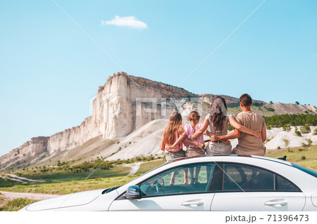 Happy family of four walking in the mountains Happy family of four walking in the mountains 71396473