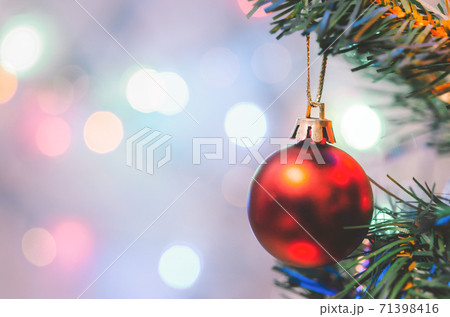 Christmas decoration. Red balls hanging on pine branches christmas tree garland and ornaments over abstract bokeh background with copy space Christmas decoration. Red balls hanging on pine branches christmas tree garland and ornaments over abstract bokeh background with copy space 71398416
