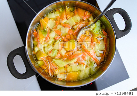 Cooking Bright Vegetable Soup on the Stove 71399491
