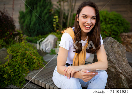 woman freelancer resting in a summer green park 71401925
