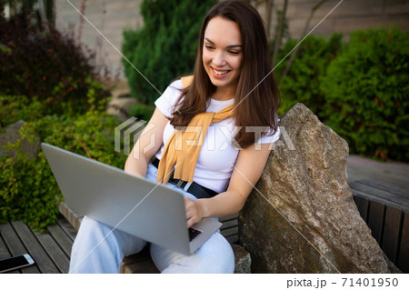 young business woman drinking coffee and working freelance on the street young business woman drinking coffee and working freelance on the street 71401950