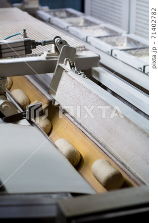 Dough on the conveyor. Dough on the conveyor. 71402782