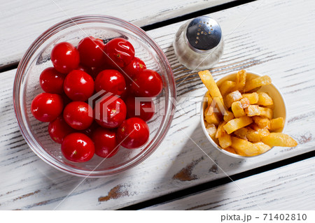 Tomatoes, fries and pepperbox. 71402810