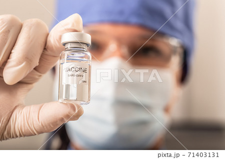 Medical researcher holding the invented Covid-19 vaccine in his hand 71403131