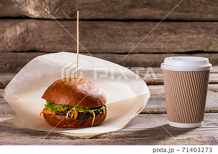 Hamburger and paper coffee cup. Hamburger and paper coffee cup. 71403273