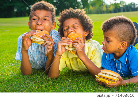 Three boys are eating. Three boys are eating. 71403610