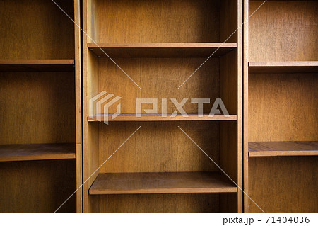 Empty wooden book shelf with or storage rack modern retro design, copy space background texture Empty wooden book shelf with or storage rack modern retro design, copy space background texture 71404036
