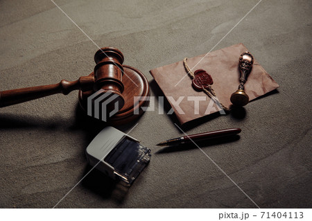 Notary seal, wooden gavel, notarized document on a table. Legality concept Notary seal, wooden gavel, notarized document on a table. Legality concept 71404113