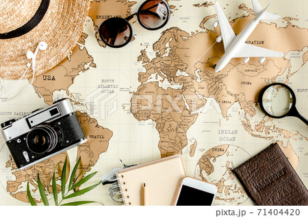 Planning vacation, travel plan, trip vacation using world map along with other travel accessories. Top view, flat lay. Planning vacation, travel plan, trip vacation using world map along with other travel accessories. Top view, flat lay. 71404420