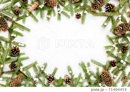 Frame made of Christmas composition with fir branches, pine cones on white background. Flat lay, top view holiday decoration concept. 71404453