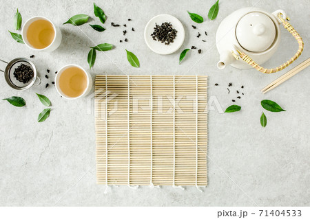 Herbal tea with two white tea cups and teapot, with green tea leaves. Flat lay, top view. Tea concept Herbal tea with two white tea cups and teapot, with green tea leaves. Flat lay, top view. Tea concept 71404533