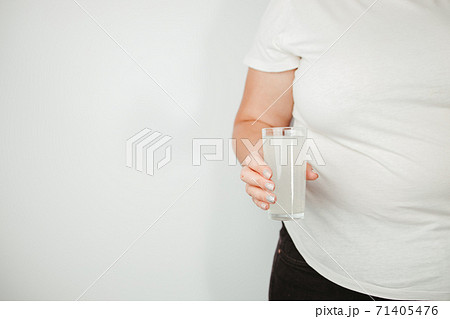 Overweight woman with carbonated soda drink Overweight woman with carbonated soda drink 71405476