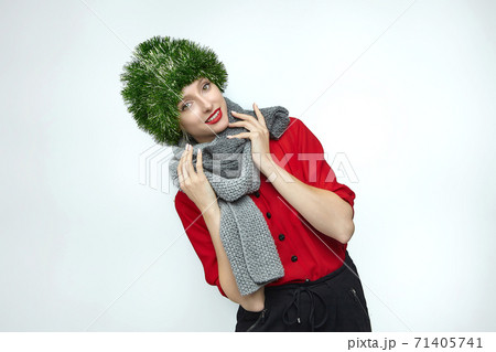 portrait of an attractive girl with a Christmas decoration on her head. photo session in the Studio on a white background portrait of an attractive girl with a Christmas decoration on her head. photo session in the Studio on a white background 71405741