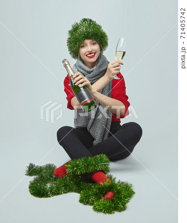 happy girl with a bottle of champagne and a glass on a white background 71405742