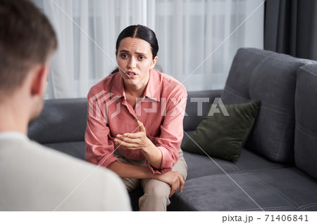 Crying woman explaining something to her psychotherapist 71406841