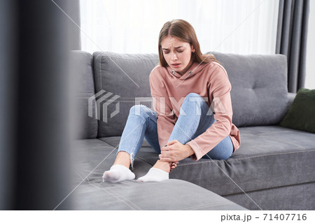 Woman suffering from achilles tendinitis 71407716