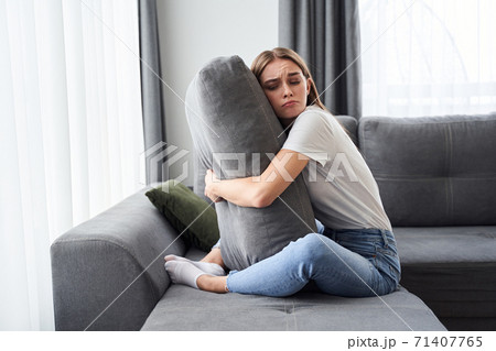 Woman hugging big pillow Woman hugging big pillow 71407765