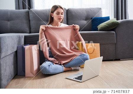 Woman appliying sweatshirt to herself 71407837
