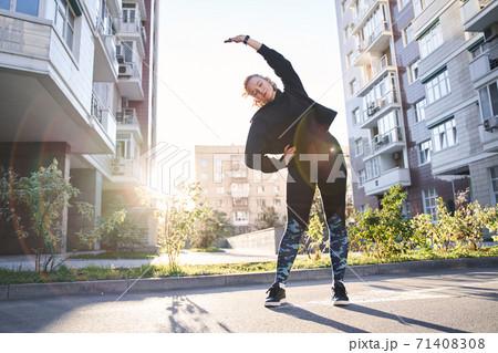 Woman warming up before jogging Woman warming up before jogging 71408308